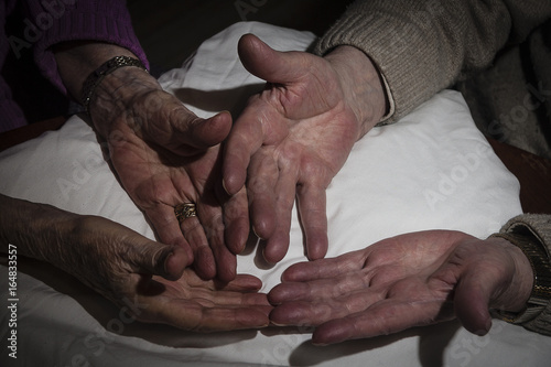 close up of a senior couple holding hands