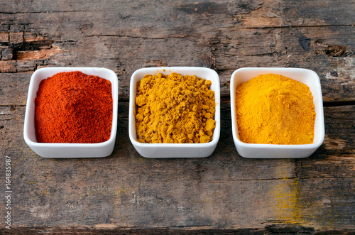 Fototapeta Naklejka Na Ścianę i Meble -  Hot red chili powder, curry and turmeric powder