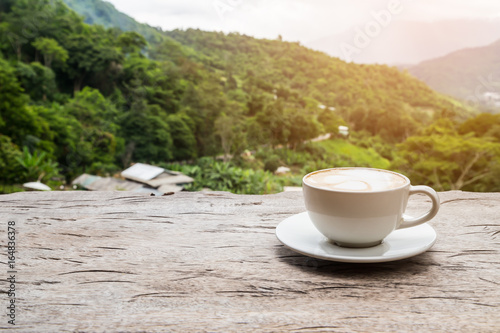 coffee on wood table with mountain view