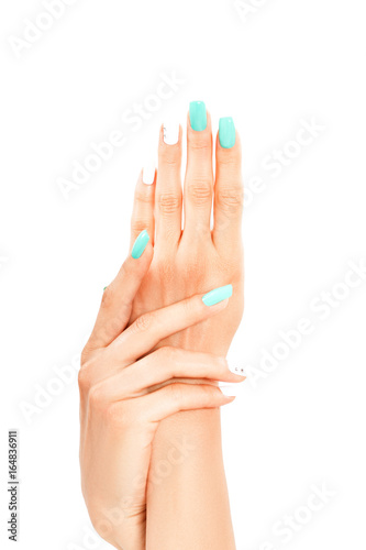 Well-groomed female hands with mint-white manicure  isolated on a white background