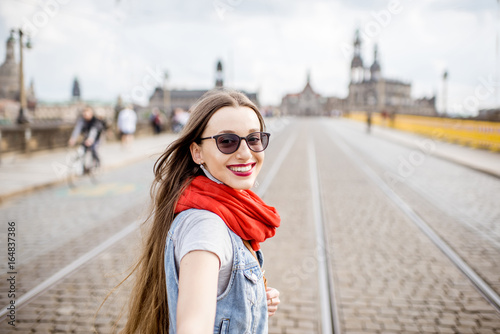 Lifestyle portrait of a business woman walking the bridge in the old town of Dresden  Germany