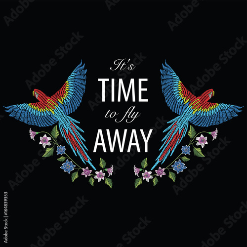 Macaw ara parrot with narcissus, tulip anfd lily flower. Embroidery stitches stylized vector illustration with text it's time to fly away. Traditional floral pattern for textile and fabrics.
