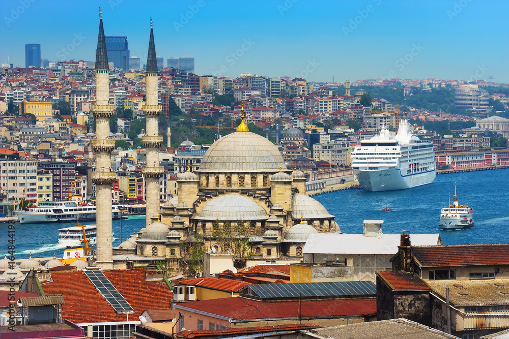 Istanbul view, Turkey. Mosque with minaret, old town, Bosphorus, part of Golden Horn, City and the cruise liner at the pier. View from the roof of the mescidi Valide Hani.