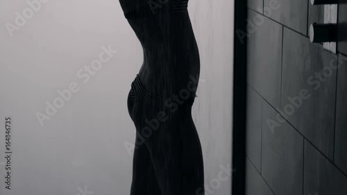 Silhouette of a sexy woman in a shower booth