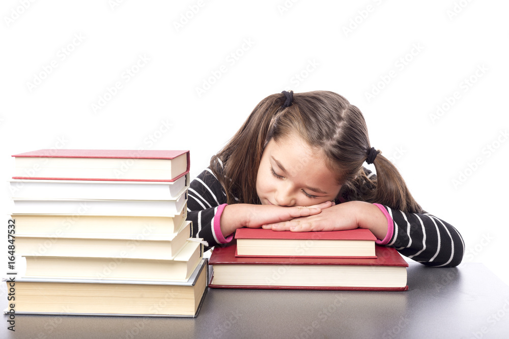 Adorable little girl sleeping on a stack of books Adorable little girl sleeping on a stack of books