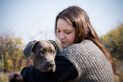 Konstfotografi Girl and her gray cane corso puppy