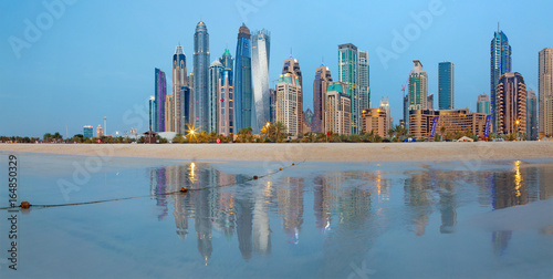 DUBAI, UAE - MARCH 28, 2017: The evening skyline of Marina towers from beach.