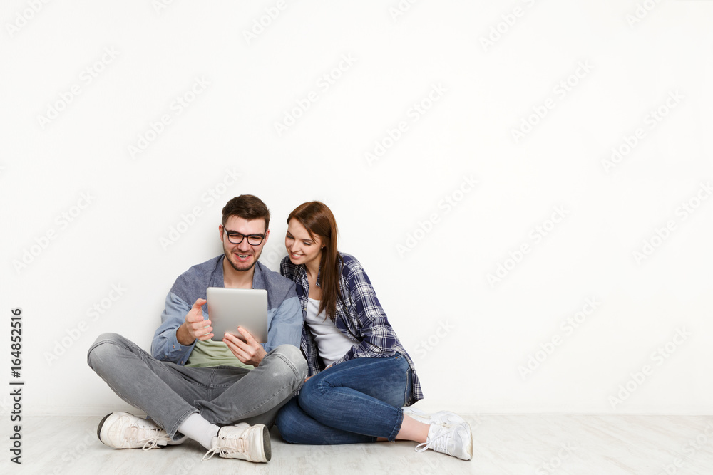 Couple ordering purchase with digital tablet