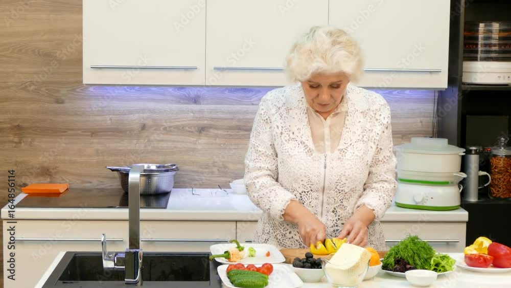 Happy Grandmother Making Salad Of Fresh Vegetables Happy Grandmother Making Salad Of Fresh Vegetables