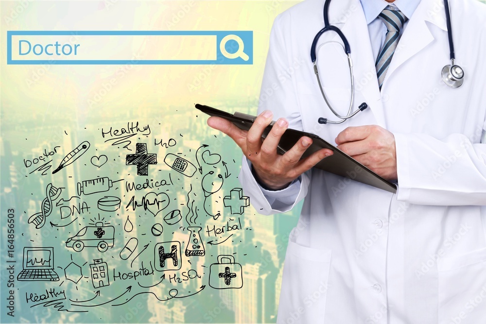Doctor works on digital tablet. Doctor works on digital tablet.