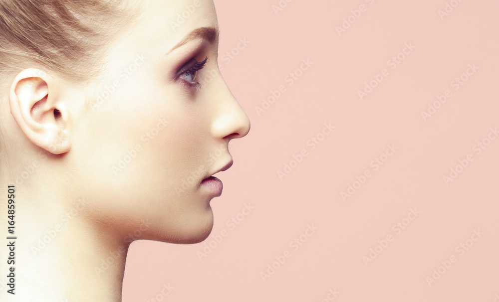 Naklejka premium Beauty close-up portrait of beautiful, fresh and healthy girl over orange background.