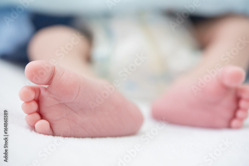 newborn's feet in baby bed. using as health care concept