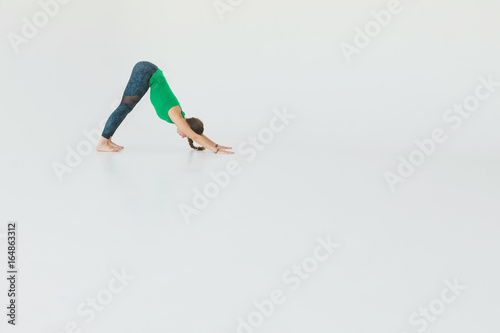 Young attractive woman practicing yoga. Young beautiful woman practicing yoga and gymnastic. Wellness concept. Classes in single sports. © Gennady Danilkin