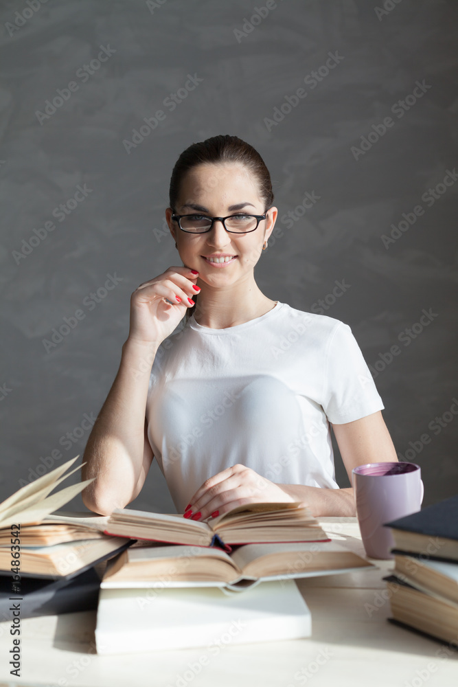 girl in library preparing for exams and reads books girl in library preparing for exams and reads books