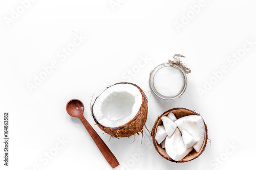 Body treatment. Coconut oil on white background top view copyspace
