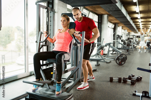 Beautiful girl working out with personal trainer