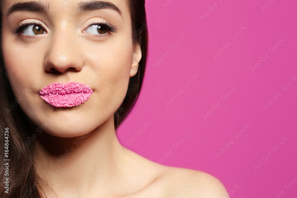 Obraz premium Beautiful young woman with lips makeup on color background
