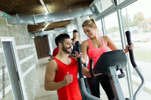 Attractive woman working cardio exercises with trainer