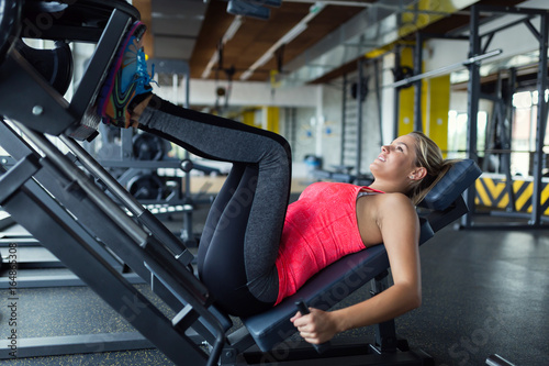 Woman doing exercises in gym for legs