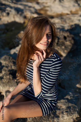 Portrait of a girl in a striped dress and long hair