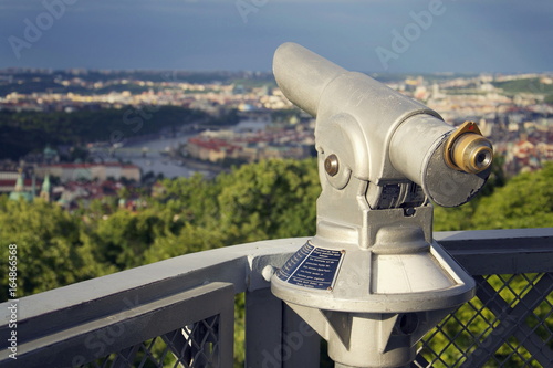 Public telescope with Prague city center in background, Czech republic
