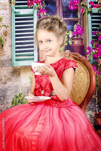 little girl in a red dress in cafe