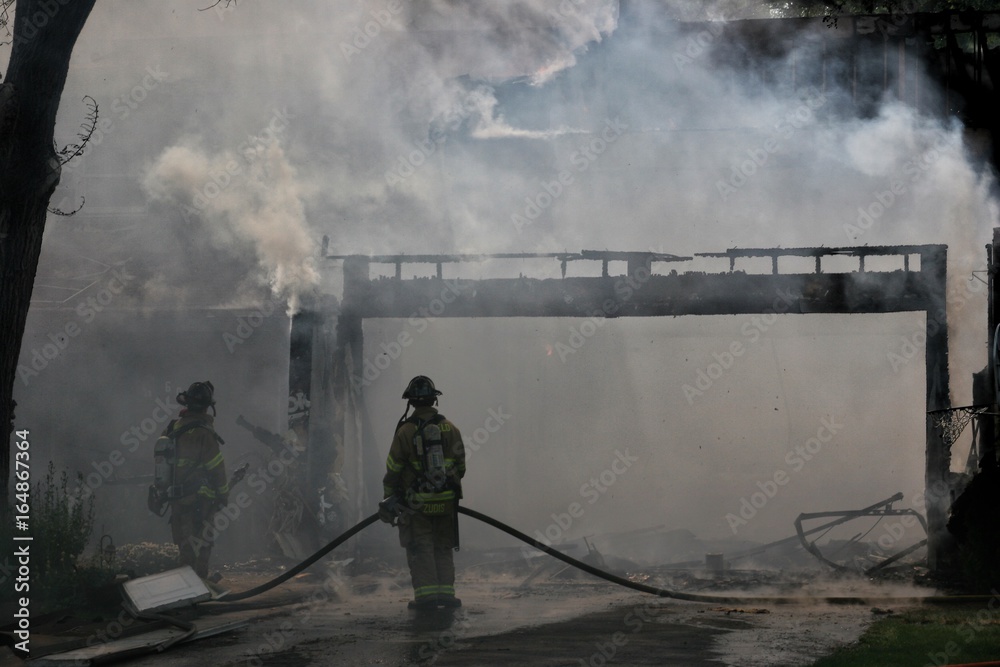 Firefighters fight burning house Firefighters fight burning house