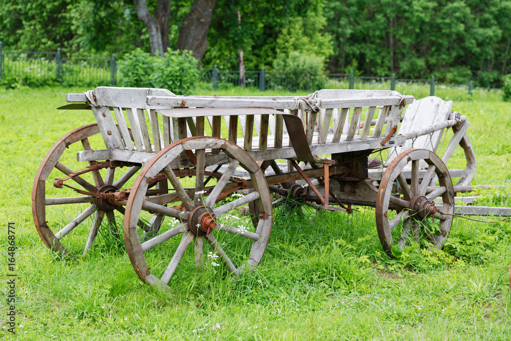  wooden cart on a meadow on a summer day