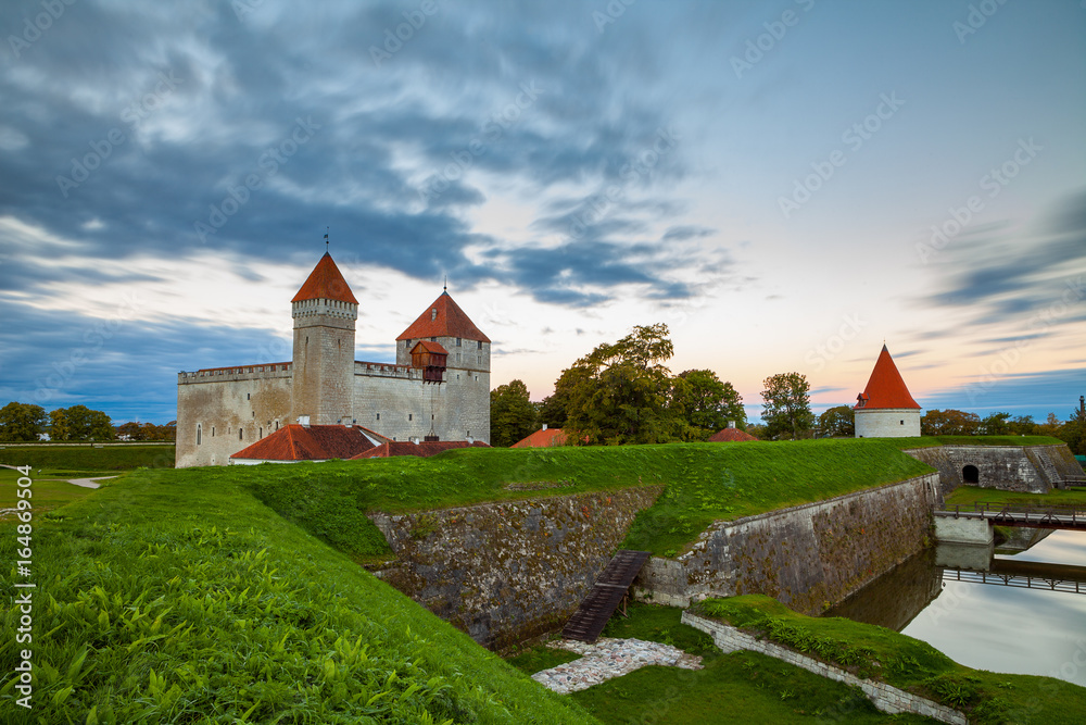Fototapeta premium Colorful sunrise over Kuressaare castle, summer time. Saaremaa island, Estonia