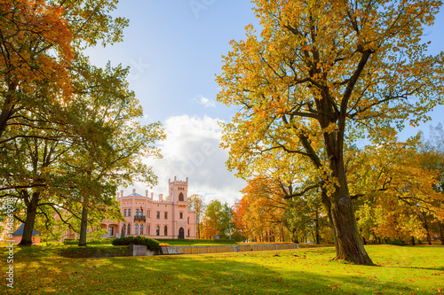 Ancient castle in city park. Sunny autumn day, fall time. photo