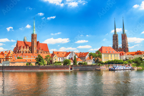 WROCLAW, POLAND - JULY 18, 2017: Wroclaw Old Town. Cathedral Island (Ostrow Tumski) is the oldest part of the city. Odra River, boats and historic buildings on a summer day.