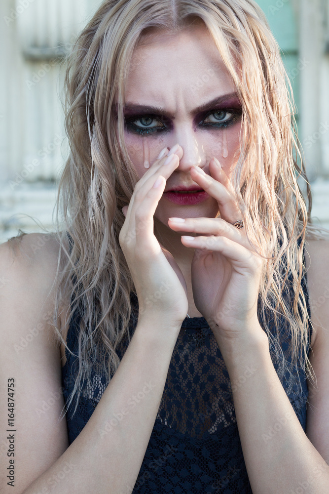 Fototapeta premium An outdoor fashion gothic style portrait of a beautiful blonde girl