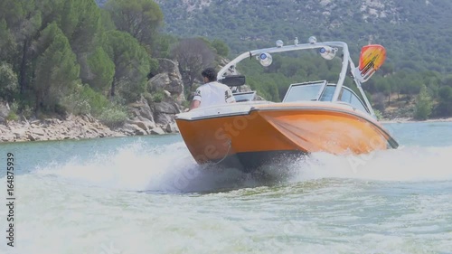 Front orange boat wakeboarding at high speed. Slow motion 2
