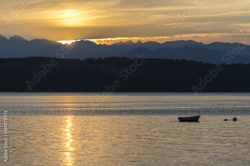 silhouette of a boat in the bay at sunset