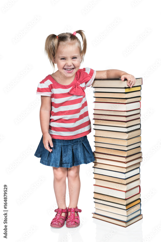 Little beautiful preschool child resting her hand on a stack of books and emotionally laughing isolated on a white background Little beautiful preschool child resting her hand on a stack of books and emotionally laughing isolated on a white background