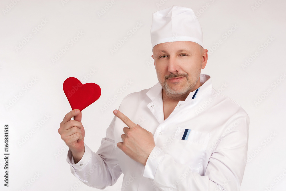 The doctor on a white background. In the hands of the red heart. The doctor on a white background. In the hands of the red heart.