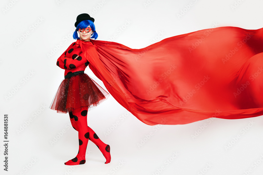 The girl with a red cape. Woman comic book character. Cosplay girl. Red