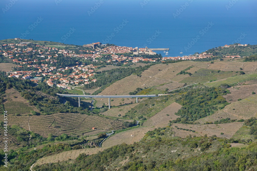Pyrenees Orientales Vermilion coast aerial landscape, vineyards fields with the village of Collioure and the Mediterranean sea, south of France, Roussillon