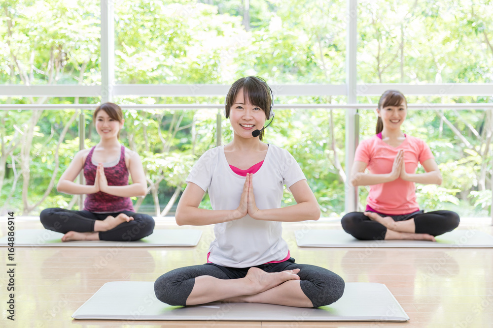 attractive asian women exercising in sports gym attractive asian women exercising in sports gym