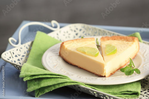 Plate with delicious slices of cheesecake on green napkin