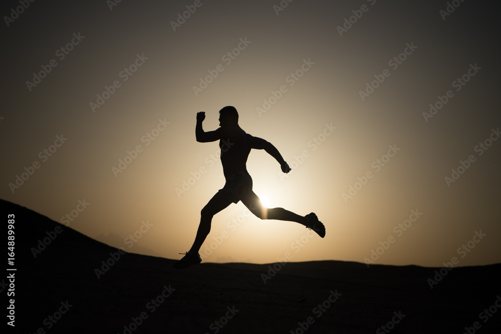 running man silhouette at sunset sky