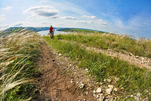 Adventure mountain biking on riverside © Aleksey