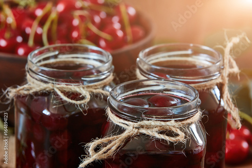 Cherry jam on wooden ground photo