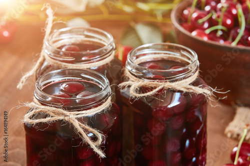 Cherry jam on wooden ground