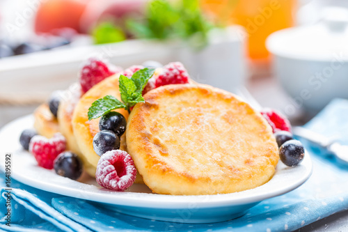 Cottage cheese pancakes, syrniki, curd fritters with berries