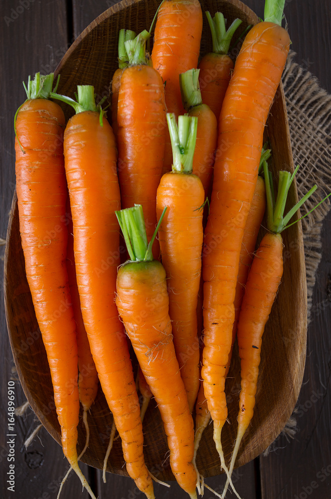 fresh carrots on wooden surface fresh carrots on wooden surface