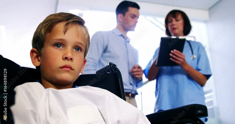Disable boy sitting on wheel chair at hospital Disable boy sitting on wheel chair at hospital