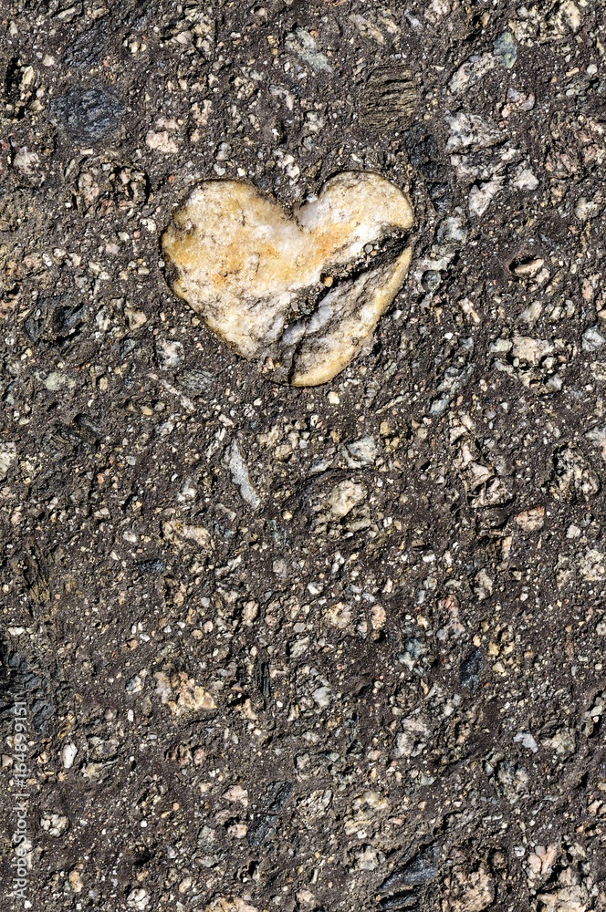 Cracked stone heart, broken heart, road Cracked stone heart, broken heart, road