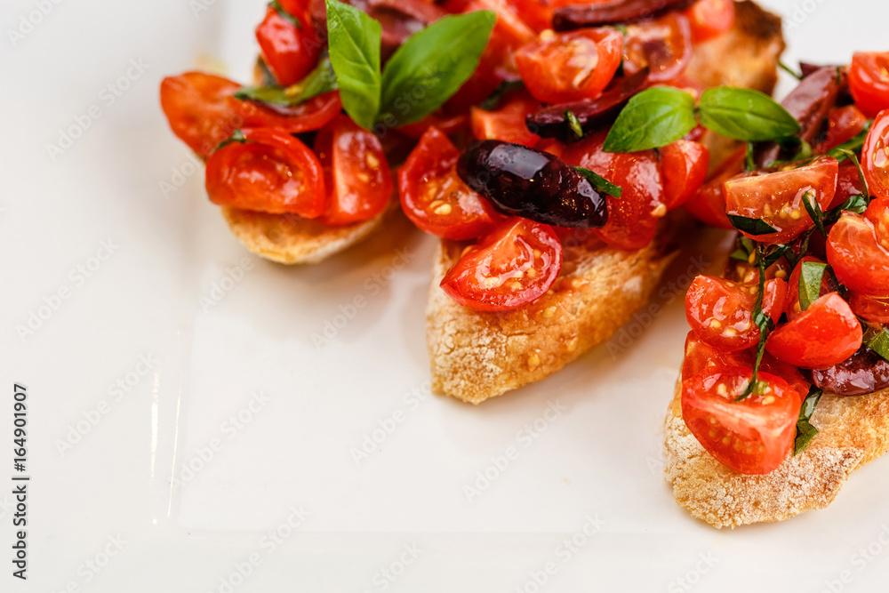 Italian bruschetta with chopped tomatoes, basil and olive