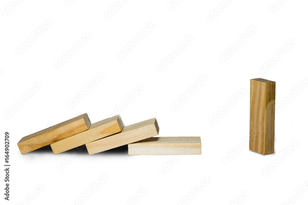 Wooden block standing and outstanding among the collapse of fall in line, business concept able to survive or dominant from destruction. Selective focus on gray background.